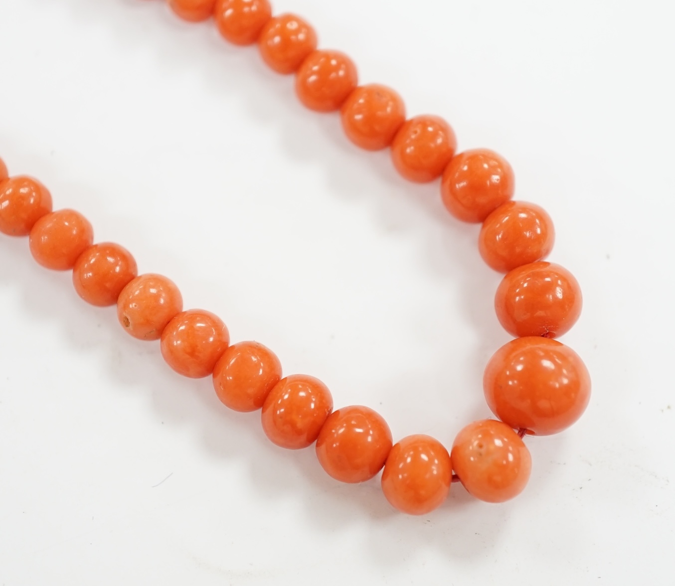 A single strand graduated coral bead necklace, with 9c clasp, 46cm. Condition - fair